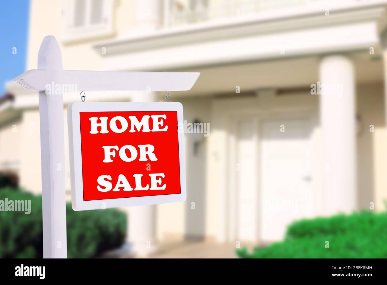 Real estate sign in front of new house for sale Stock Photo - Alamy