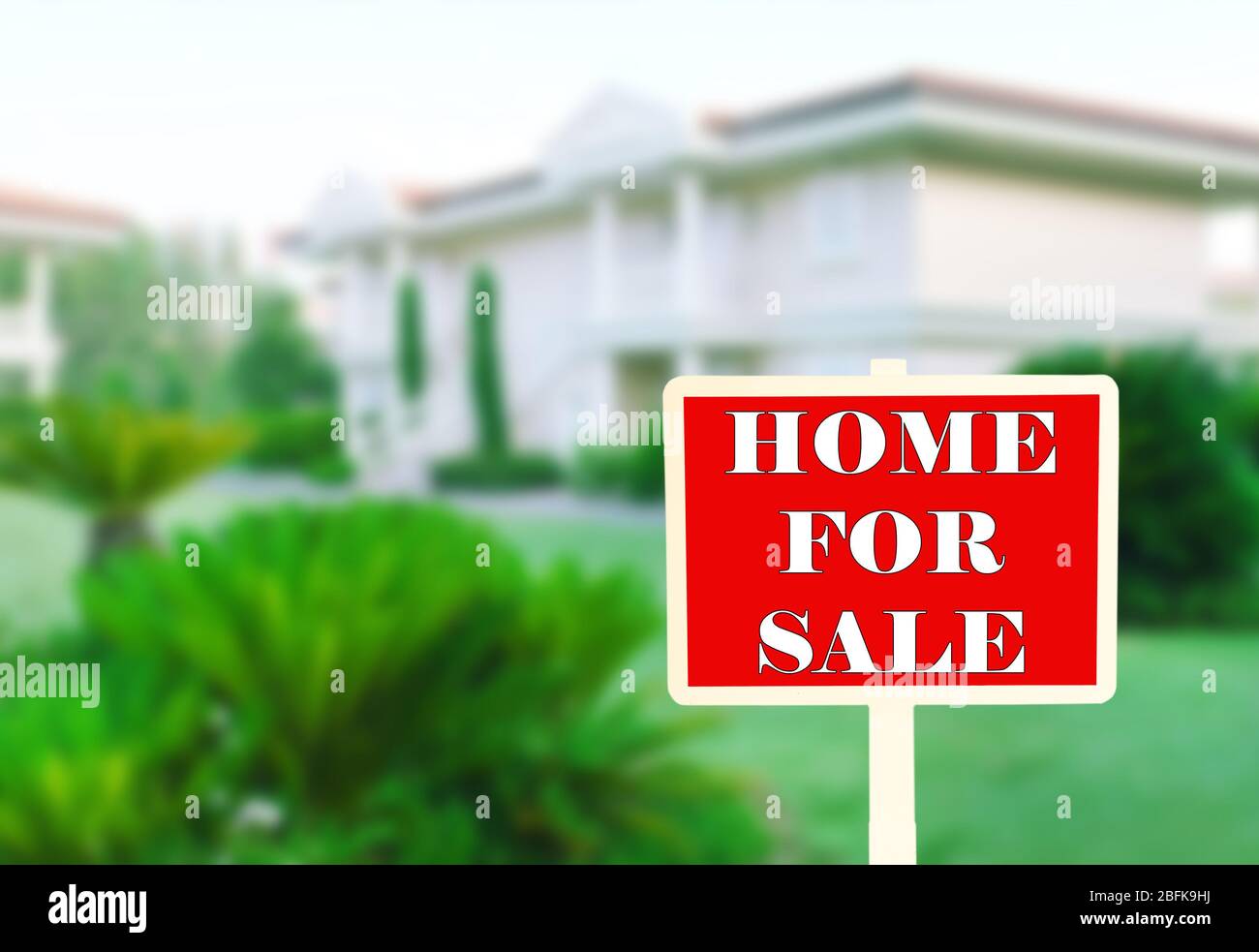 Real estate sign in front of new house for sale Stock Photo - Alamy
