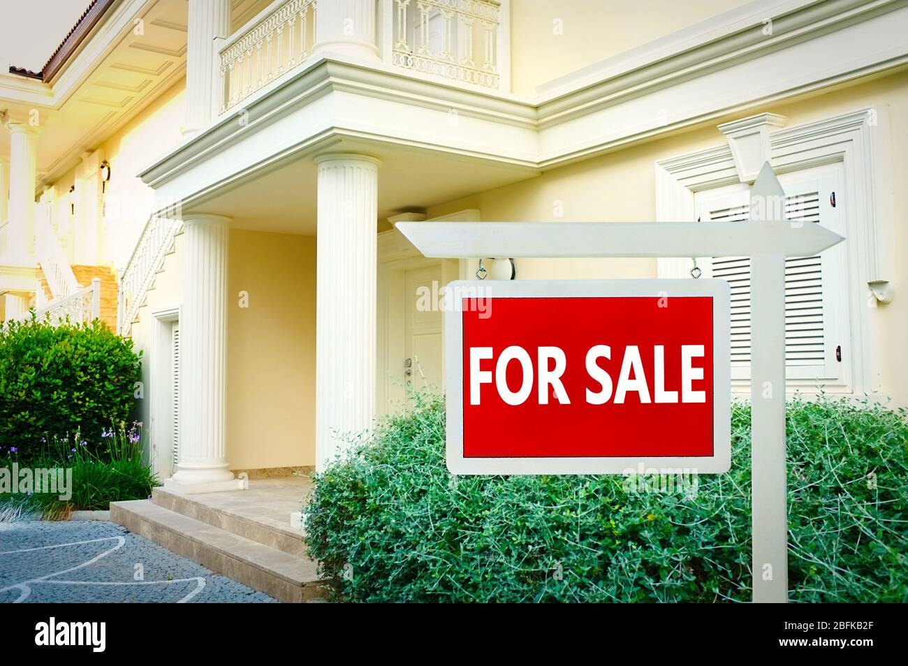 Real estate sign in front of new house for sale Stock Photo - Alamy