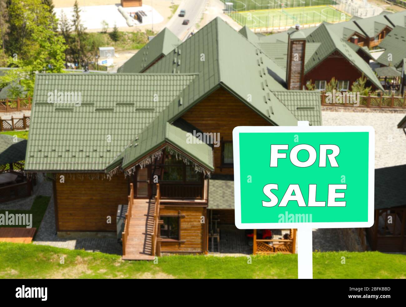 Real estate sign in front of new house for sale Stock Photo - Alamy