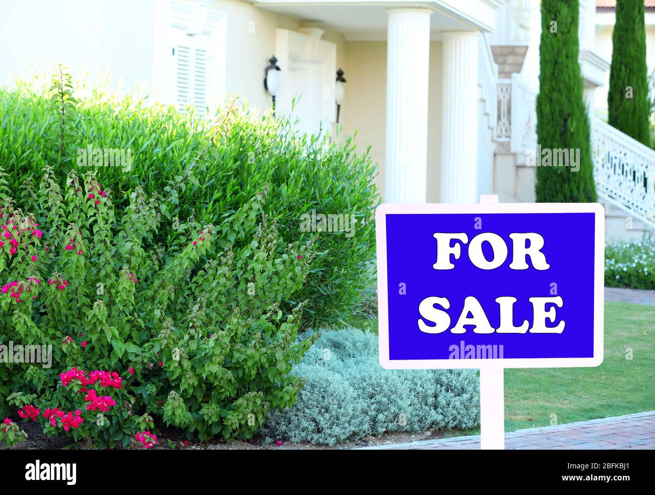 Real estate sign in front of new house for sale Stock Photo - Alamy