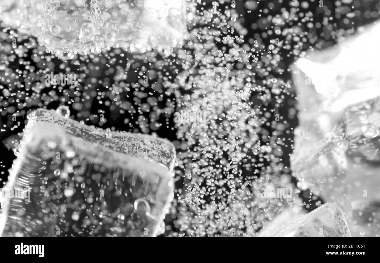 ice cube in fizzy splashing water with soda bubble Stock Photo - Alamy