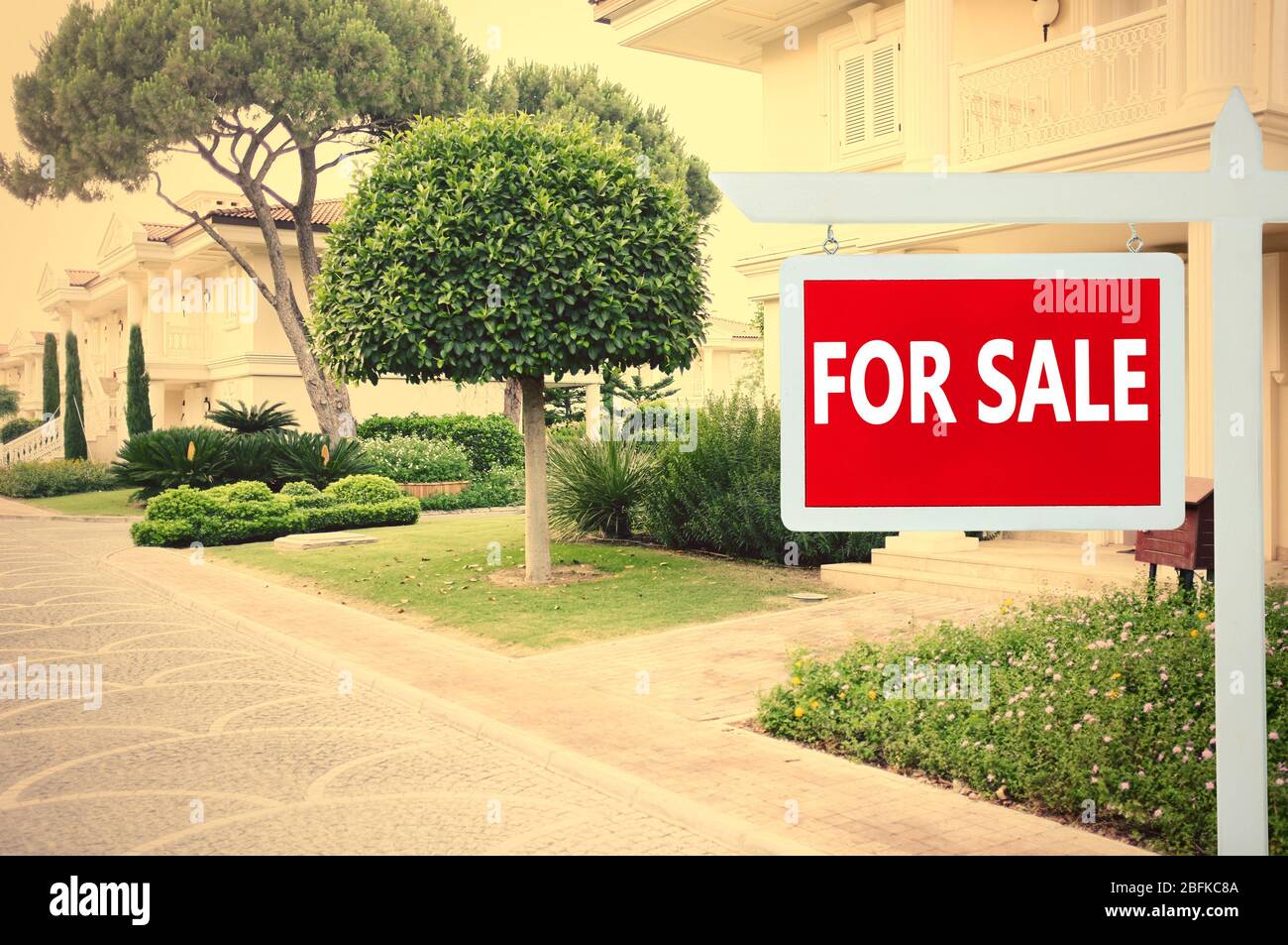 Real estate sign in front of new house for sale Stock Photo - Alamy