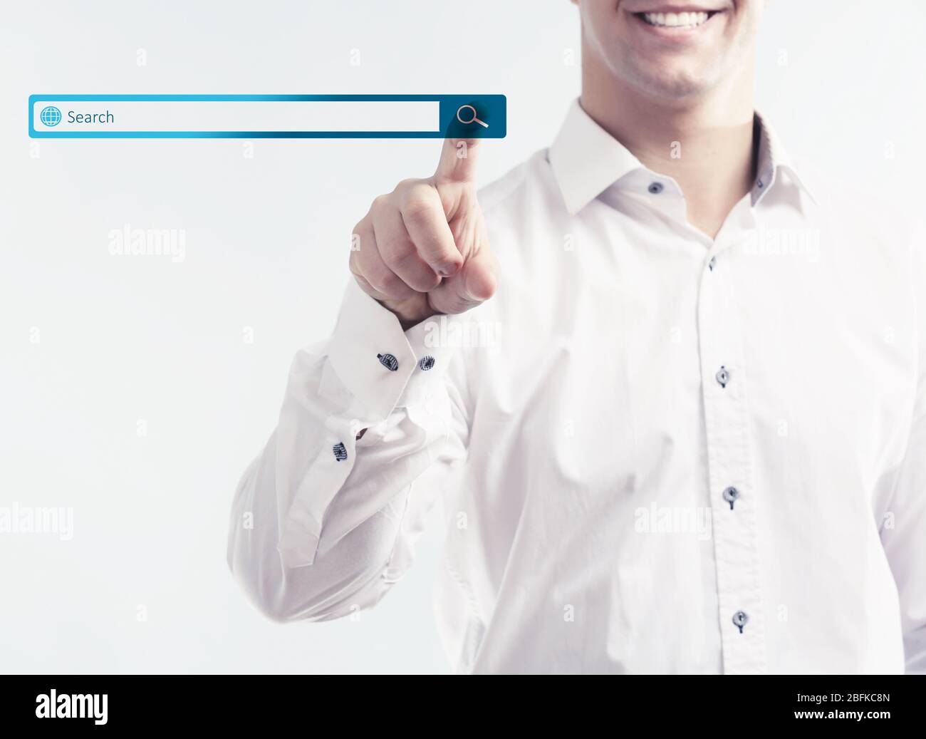 Searching system - businessman pressing search button Stock Photo