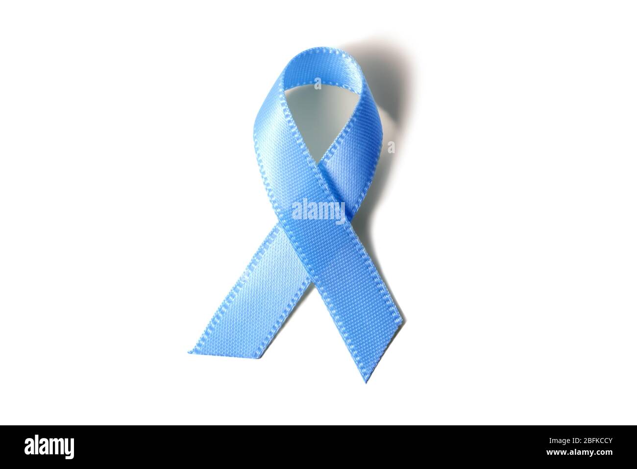 Blue ribbon symbolic for prostate cancer awareness campaign and men health isolated on white background. Stock Photo