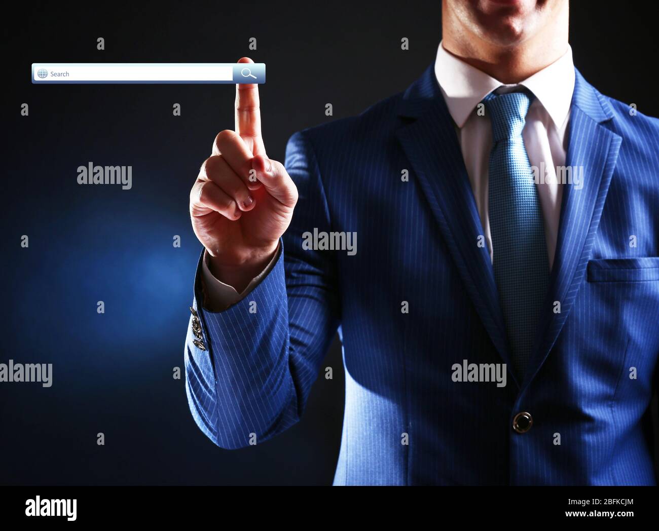 Searching system - businessman pressing search button Stock Photo