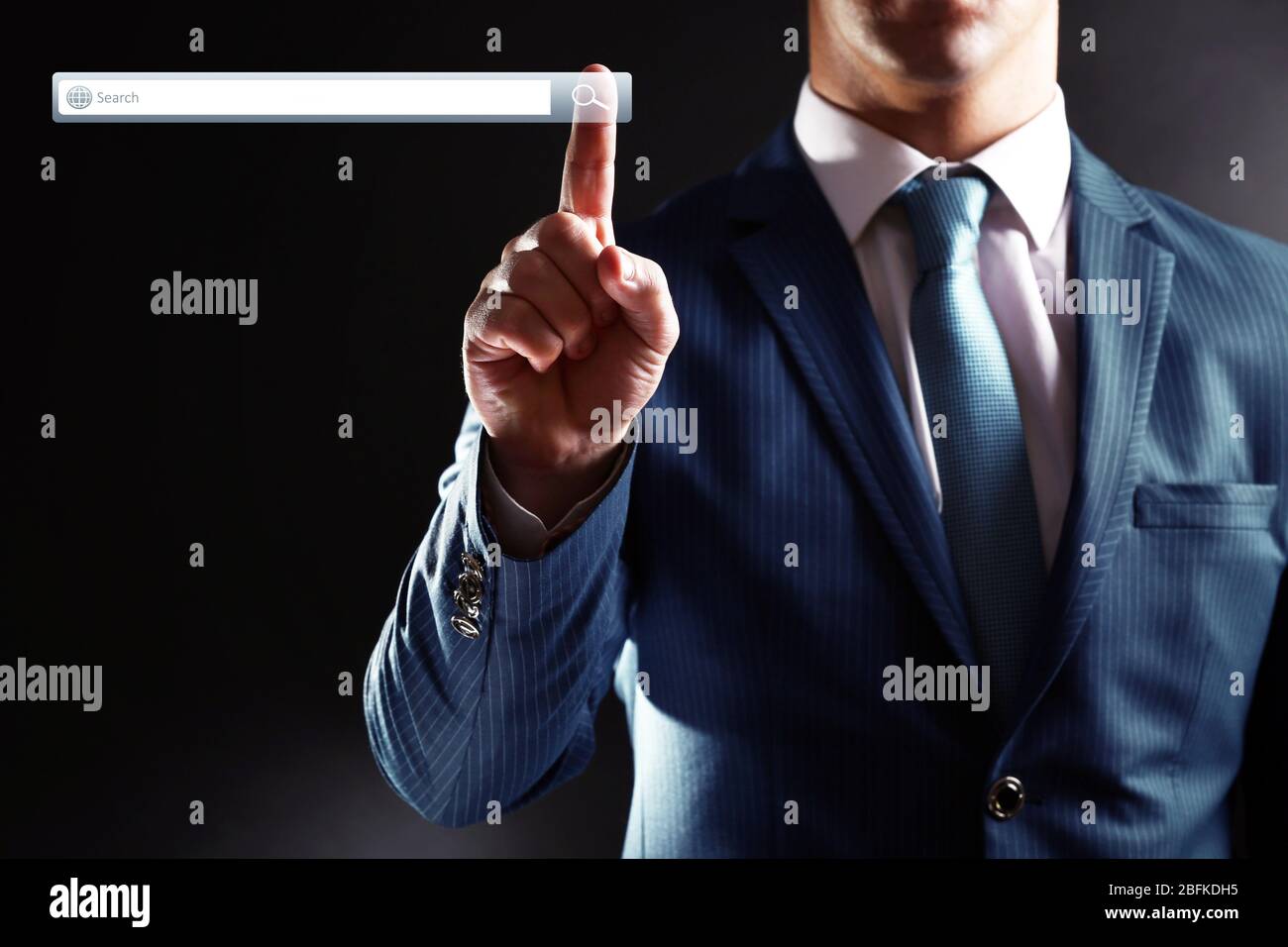 Searching system - businessman pressing search button Stock Photo