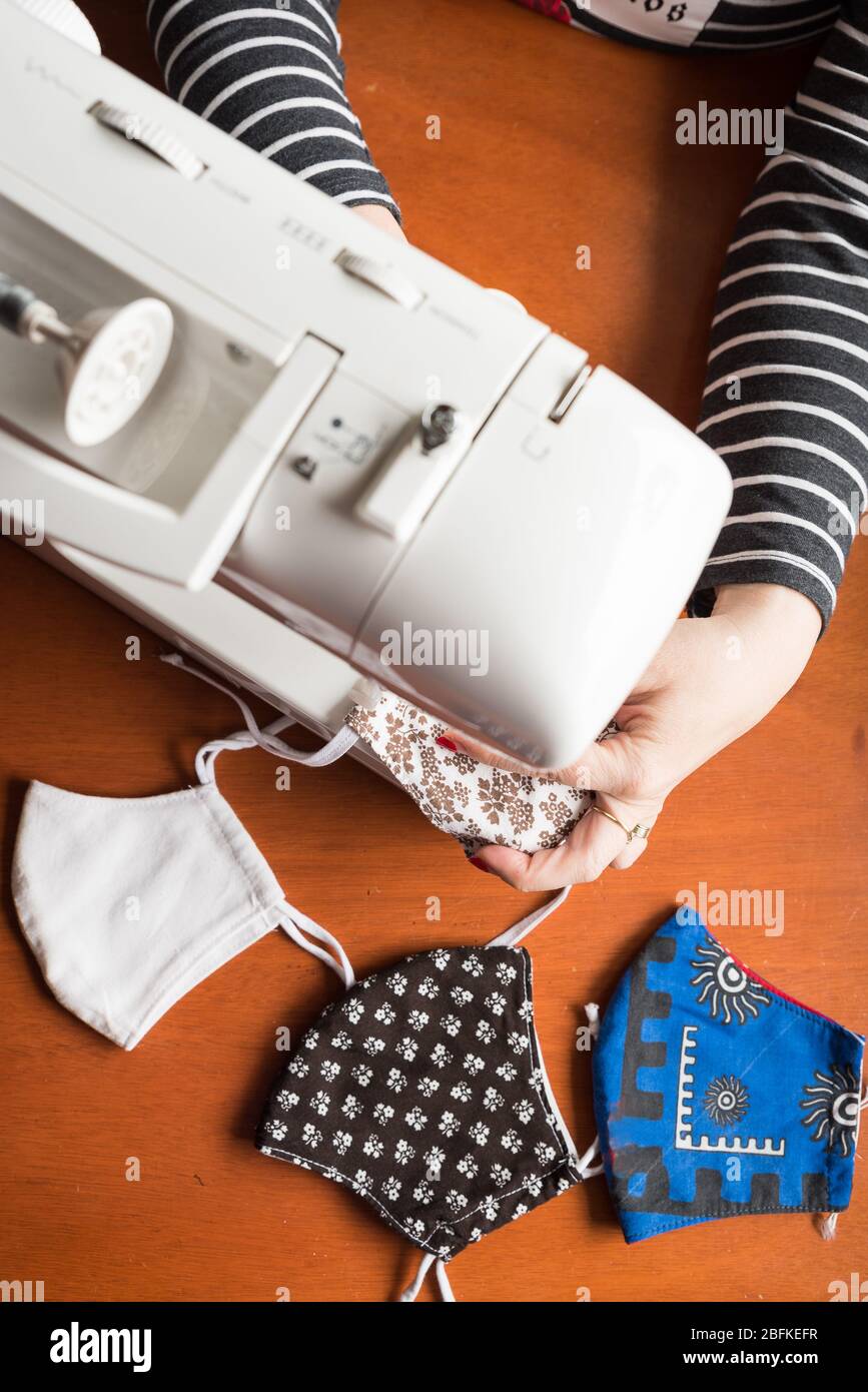 Young woman making home made breathing mask, corona virus protection ...