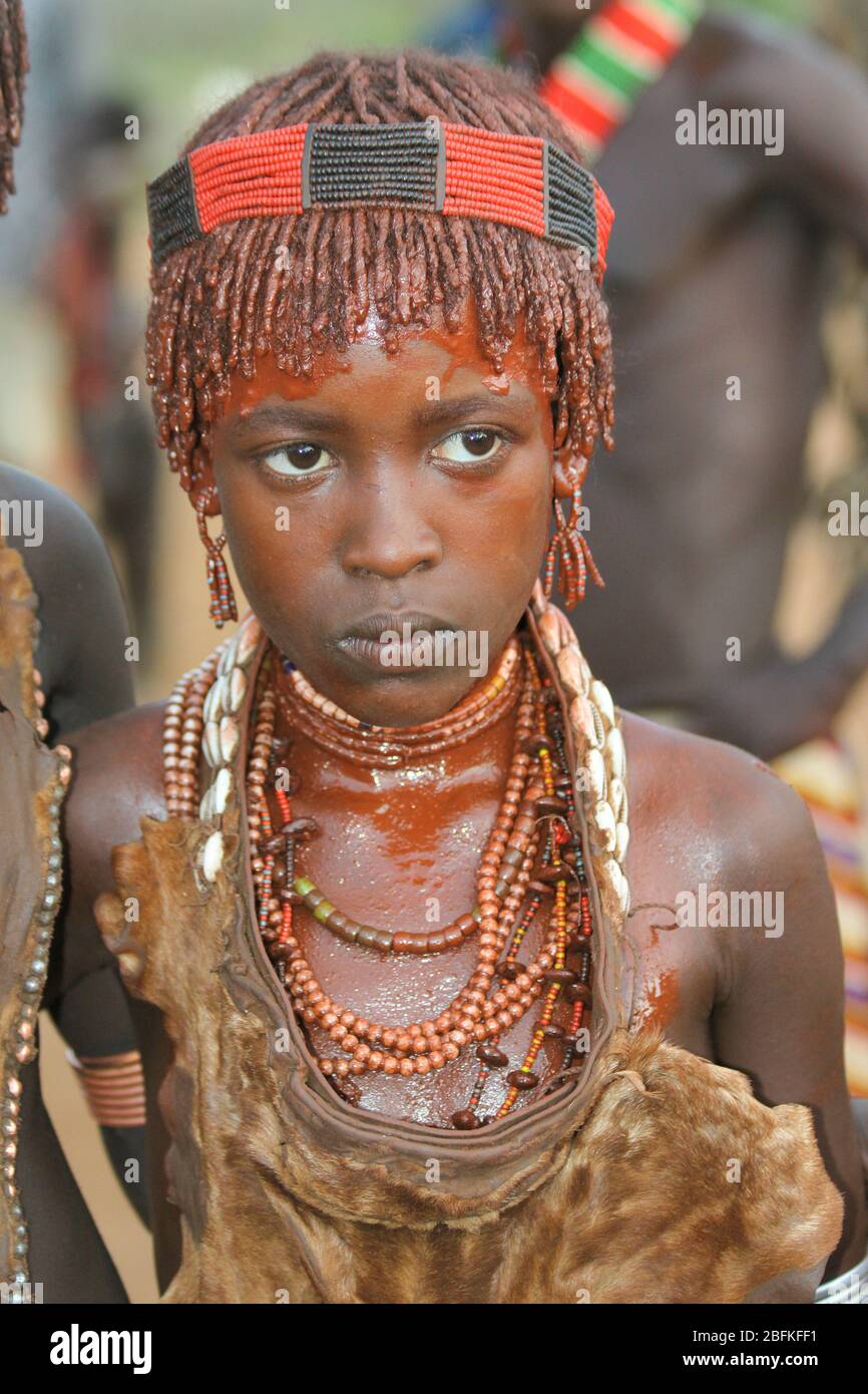 Portrait of a young Woman of the Hamer Tribe The hair is coated with ochre mud and animal fat Photographed in the Omo River Valley, Ethiopia Stock Photo