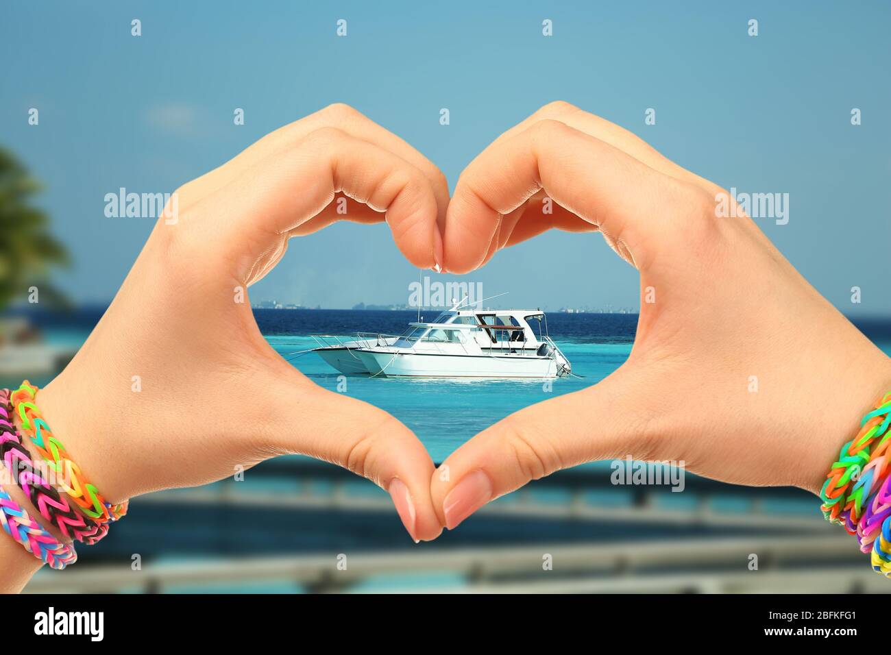 Woman holds hands in the shape of a heart on nature background Stock ...