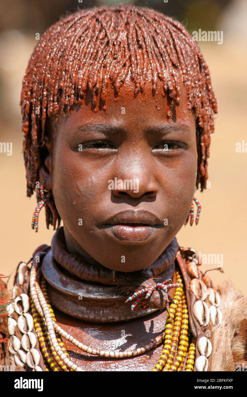 Portrait of a young Woman of the Hamer Tribe The hair is coated with ochre mud and animal fat Photographed in the Omo River Valley, Ethiopia Stock Photo