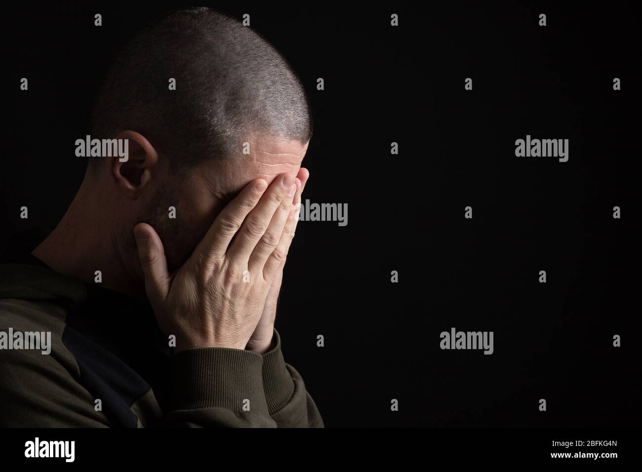 a man cries covering his face with his hands Stock Photo - Alamy