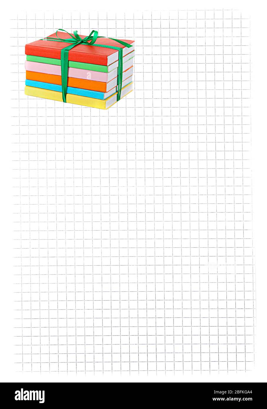 Stack of books with ribbon on paper background Stock Photo - Alamy