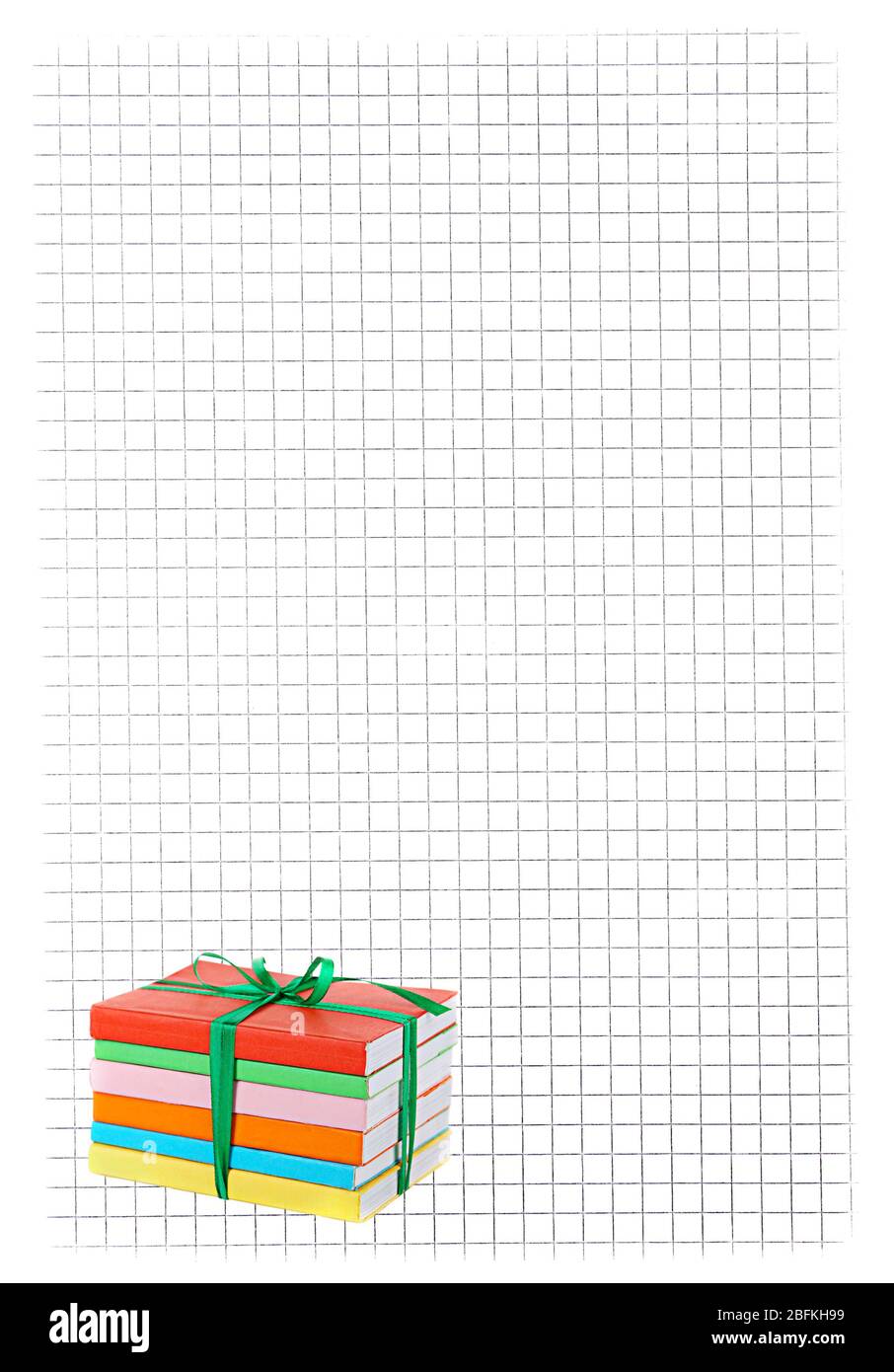 Stack of books with ribbon on paper background Stock Photo - Alamy