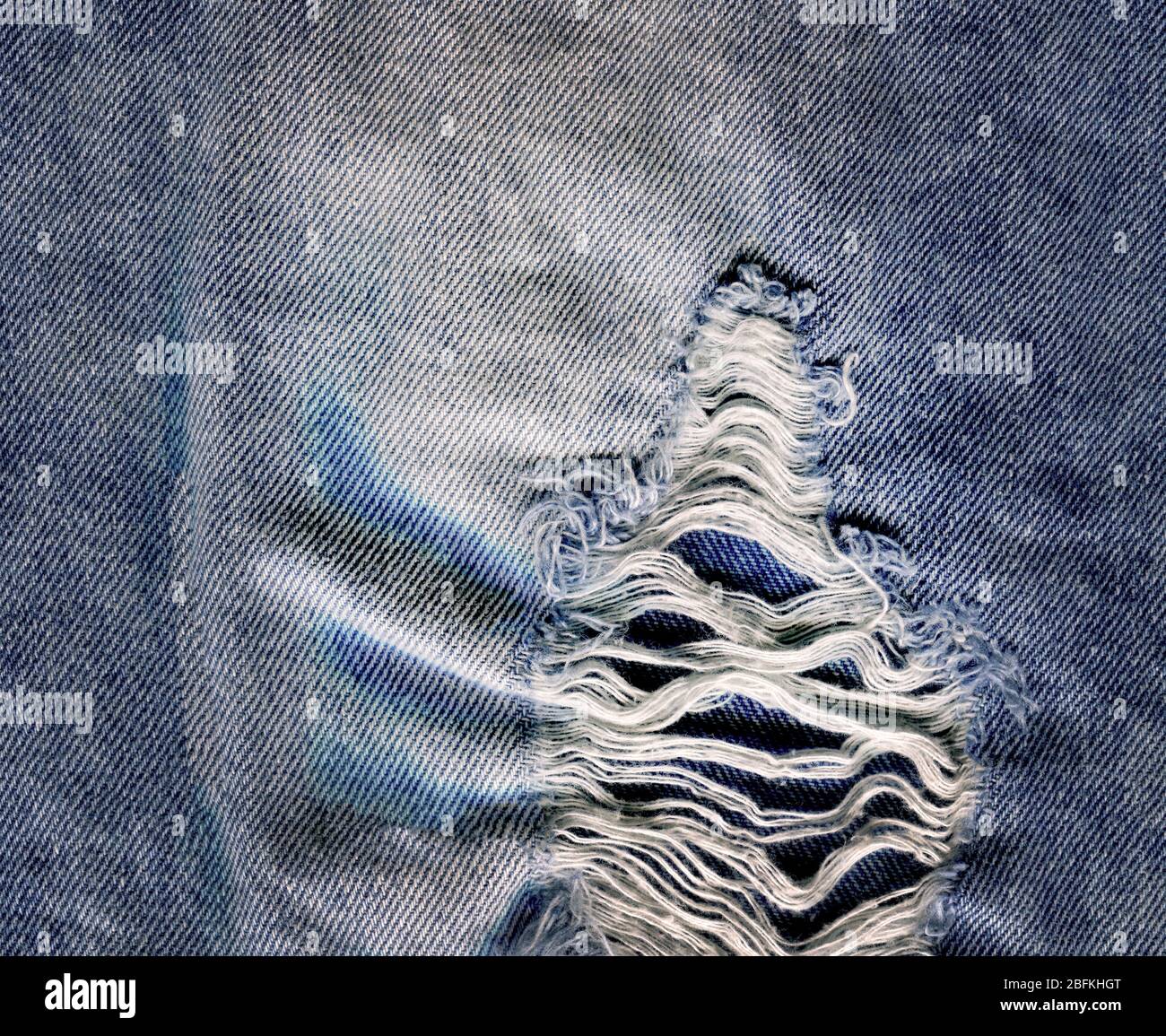 Denim jeans background with old torn. Jeans torn denim texture. Denim