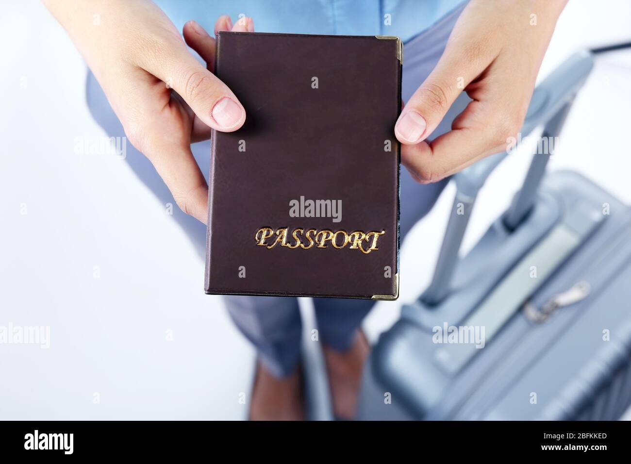 Hands holding passport hi-res stock photography and images - Alamy