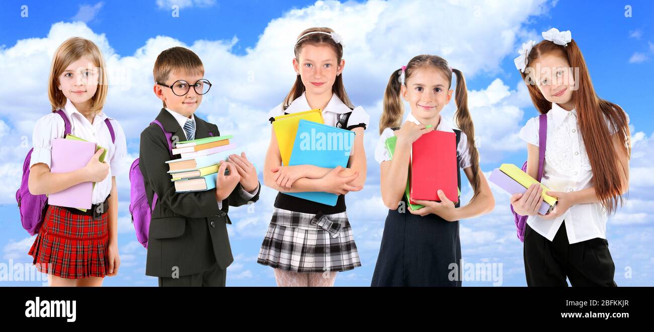 Schoolchilds on blue sky background Stock Photo