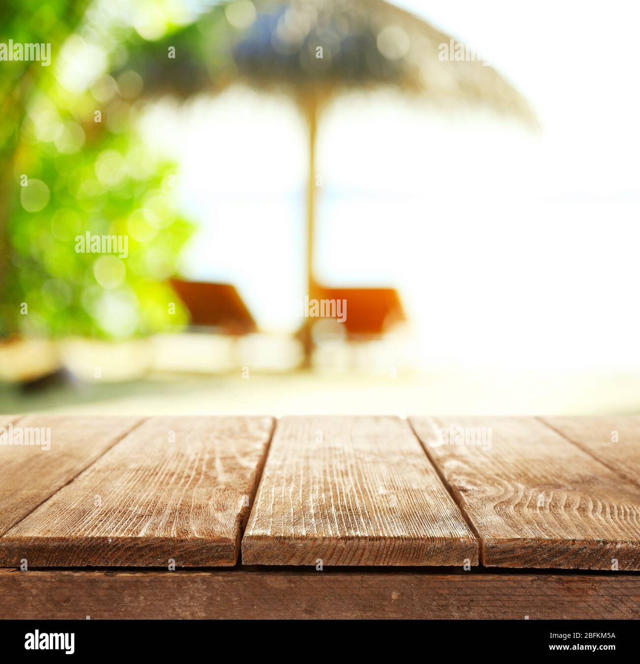 Wooden desk on beach background Stock Photo Alamy