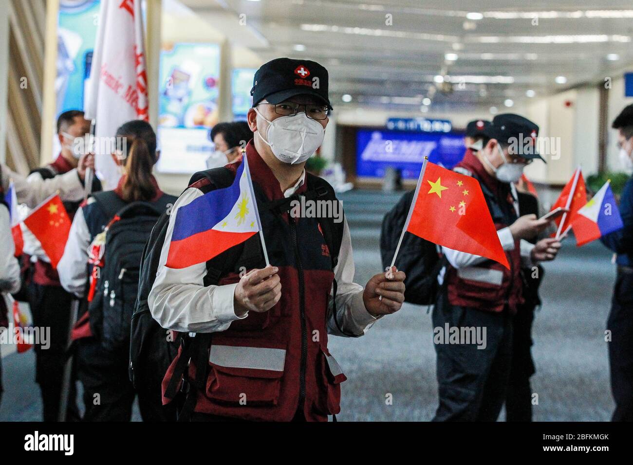 (200419) -- PARANAQUE CITY, April 19, 2020 (Xinhua) -- Members of the Chinese Anti-Epidemic Medical Expert Team wave goodbye as they leave Manila for China at the Manila Ninoy Aquino International Airport (NAIA) in Paranaque City, the Philippines, on April 19, 2020. The Philippines on Sunday thanked China anew for its help, saying the crucial medical supplies donated by the Chinese government and the ideas shared by the Chinese experts have 'provided a lifeline' to the Philippines' efforts to step up the fight against the COVID-19. Philippine Health Secretary Francisco Duque made the remark Stock Photo
