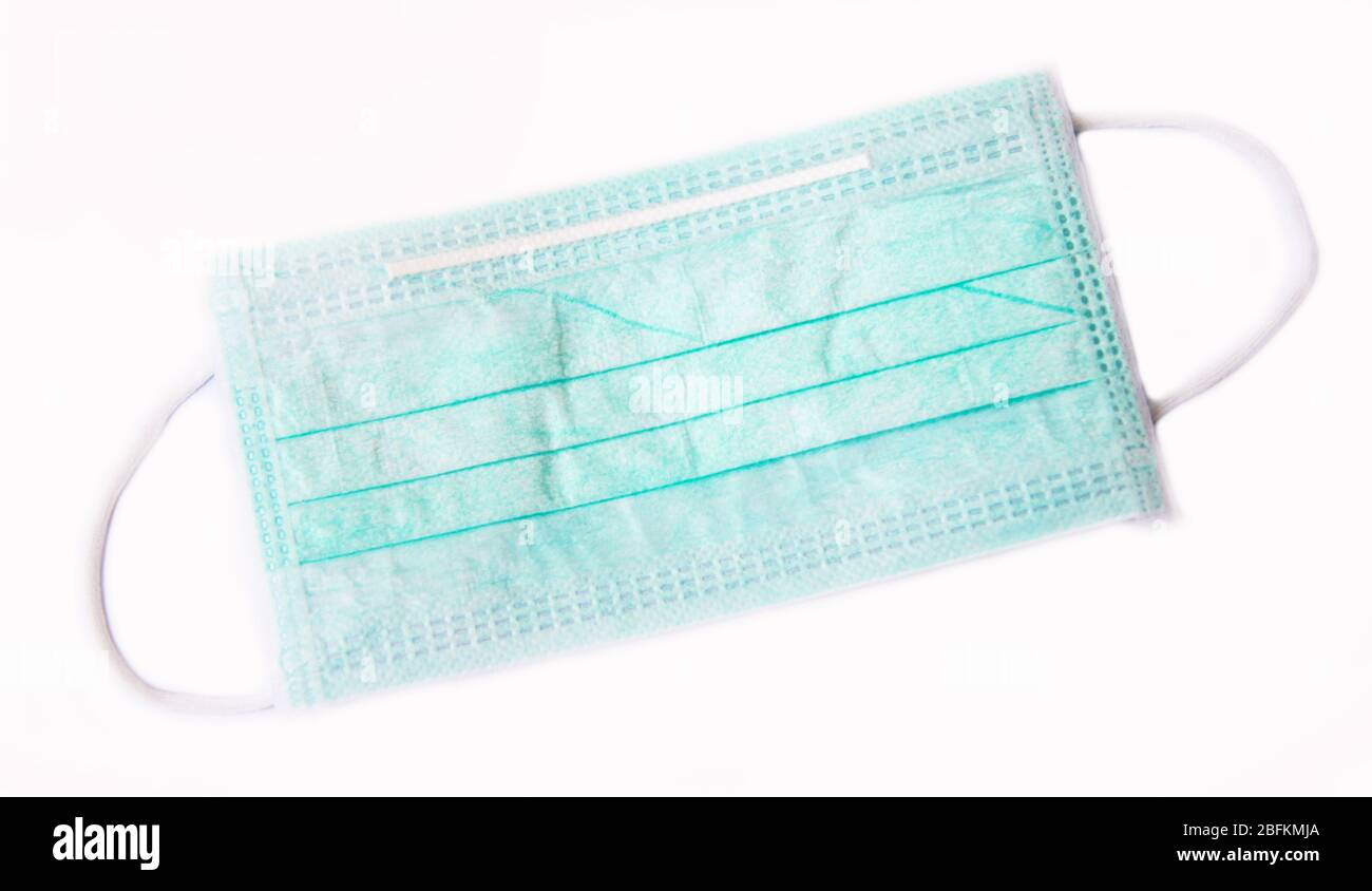 green surgical  mask for protection from corona virus on white background Stock Photo