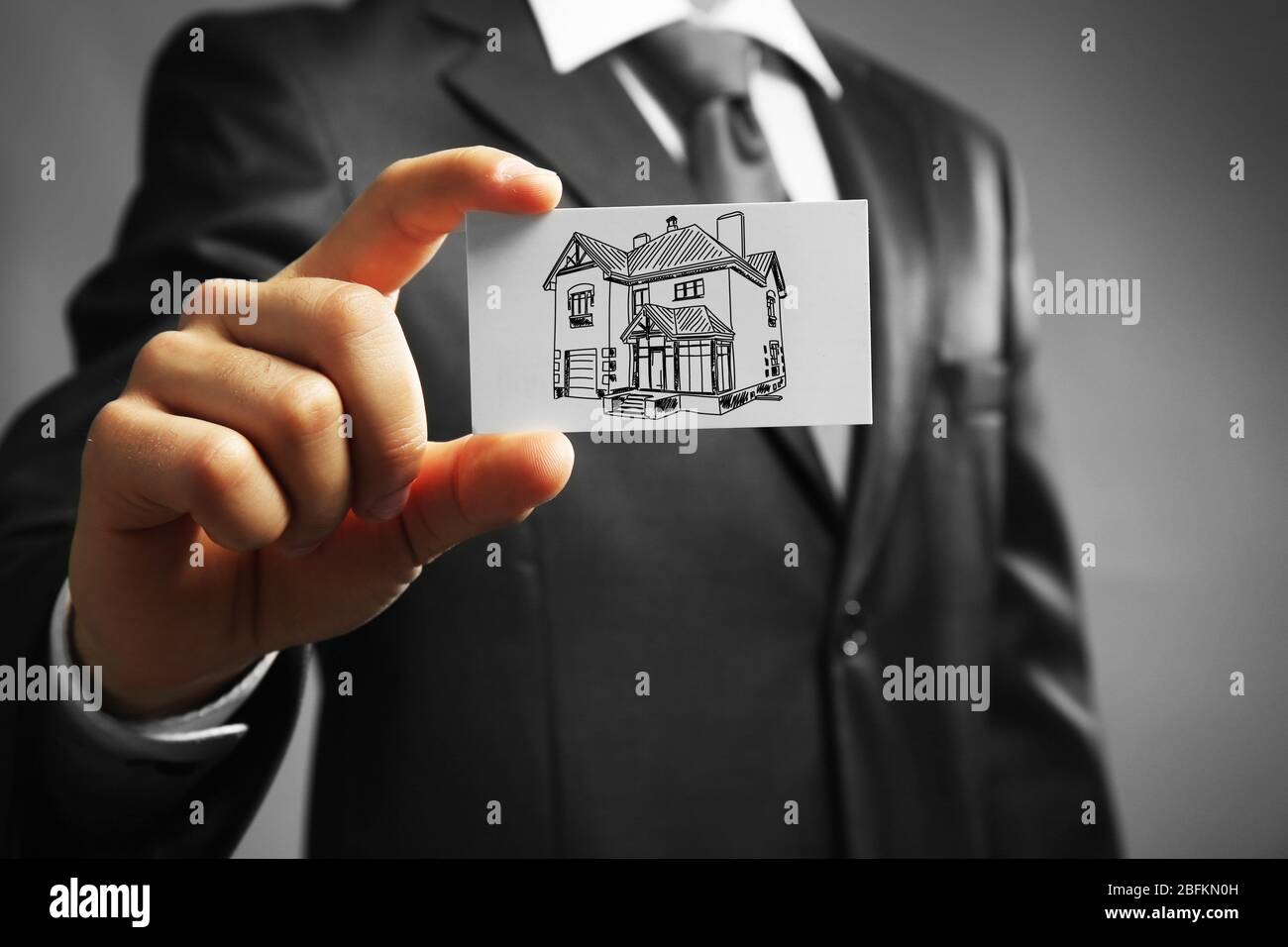 Businessman with house picture, concept real estate Stock Photo - Alamy