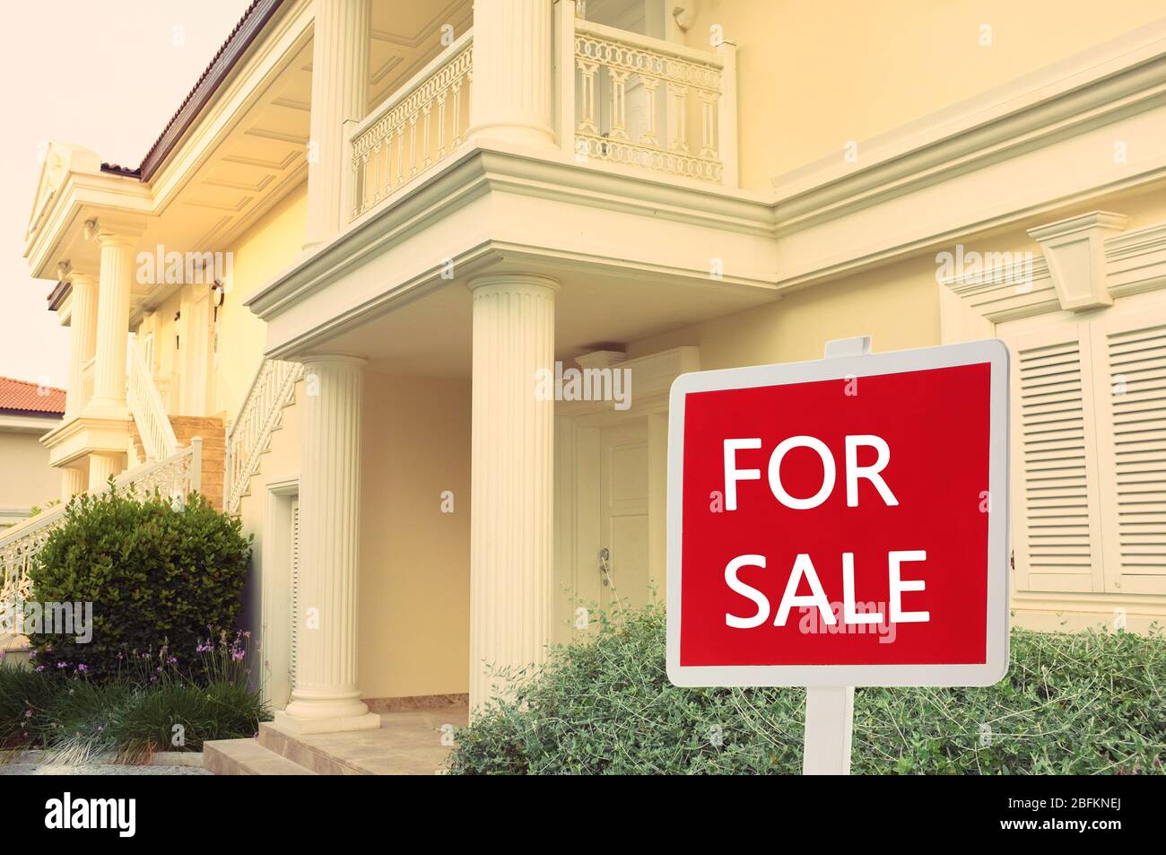 Real estate sign in front of new house for sale Stock Photo - Alamy