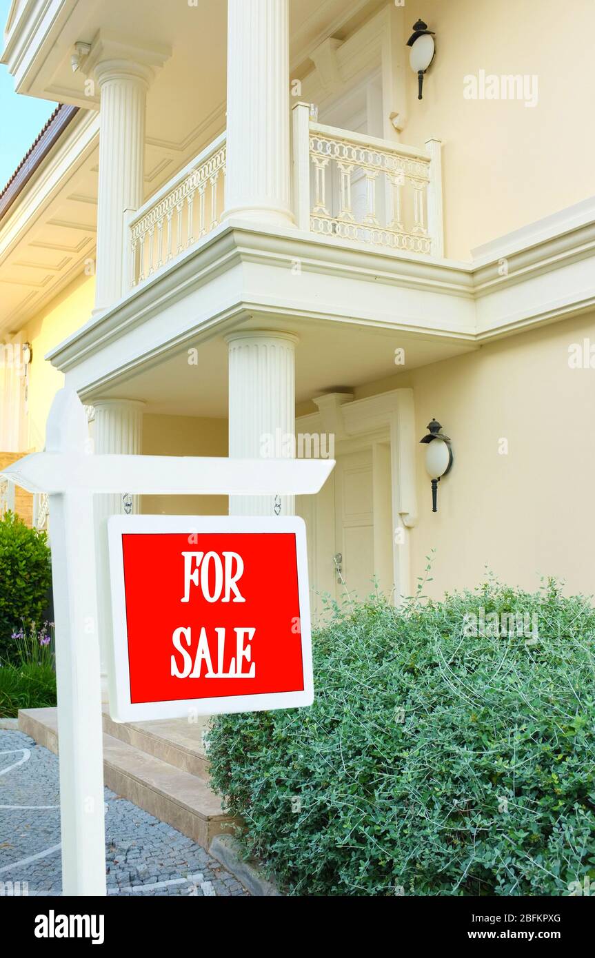 Real estate sign in front of new house for sale Stock Photo - Alamy