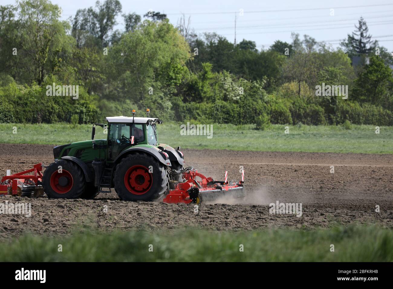 Farmer with his tractor on the field Stock Photo - Alamy