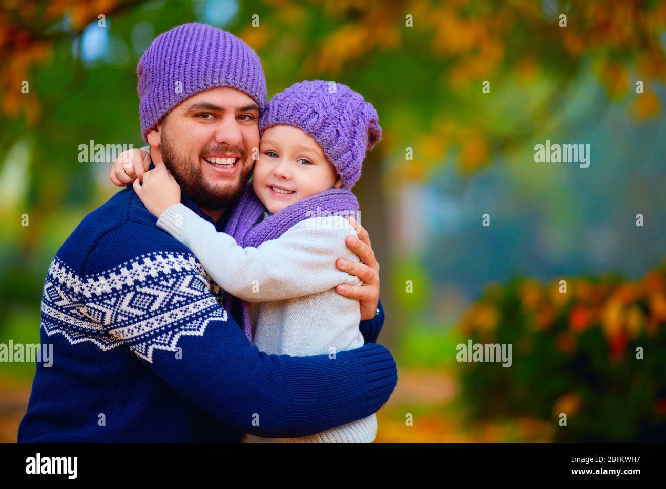 portrait of happy father and son embracing in autumn park Stock Photo ...