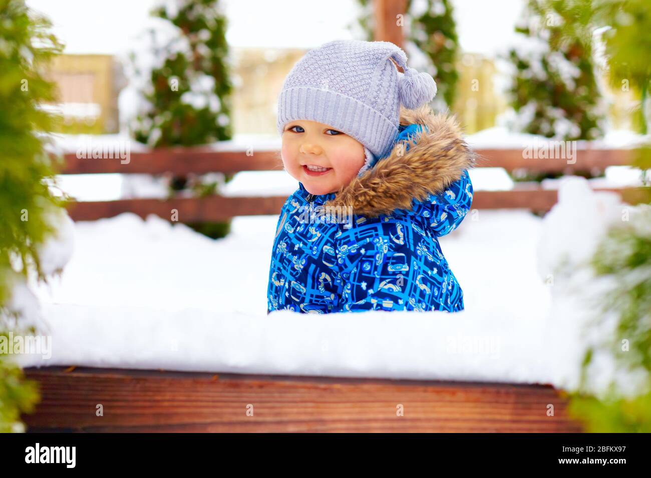 cute little baby boy on the winter walk in park Stock Photo
