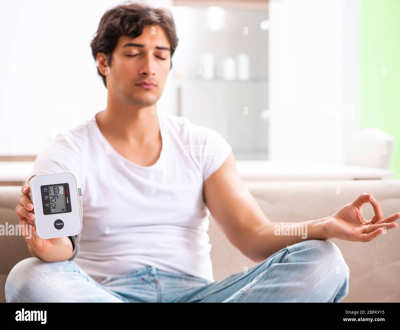 The young man measuring blood pressure at home Stock Photo - Alamy