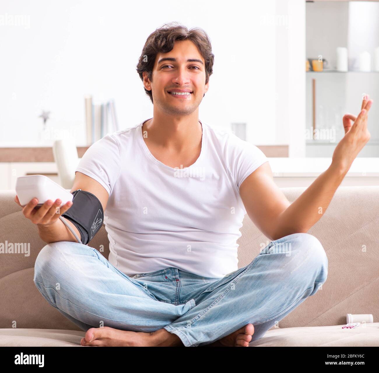 The young man measuring blood pressure at home Stock Photo - Alamy