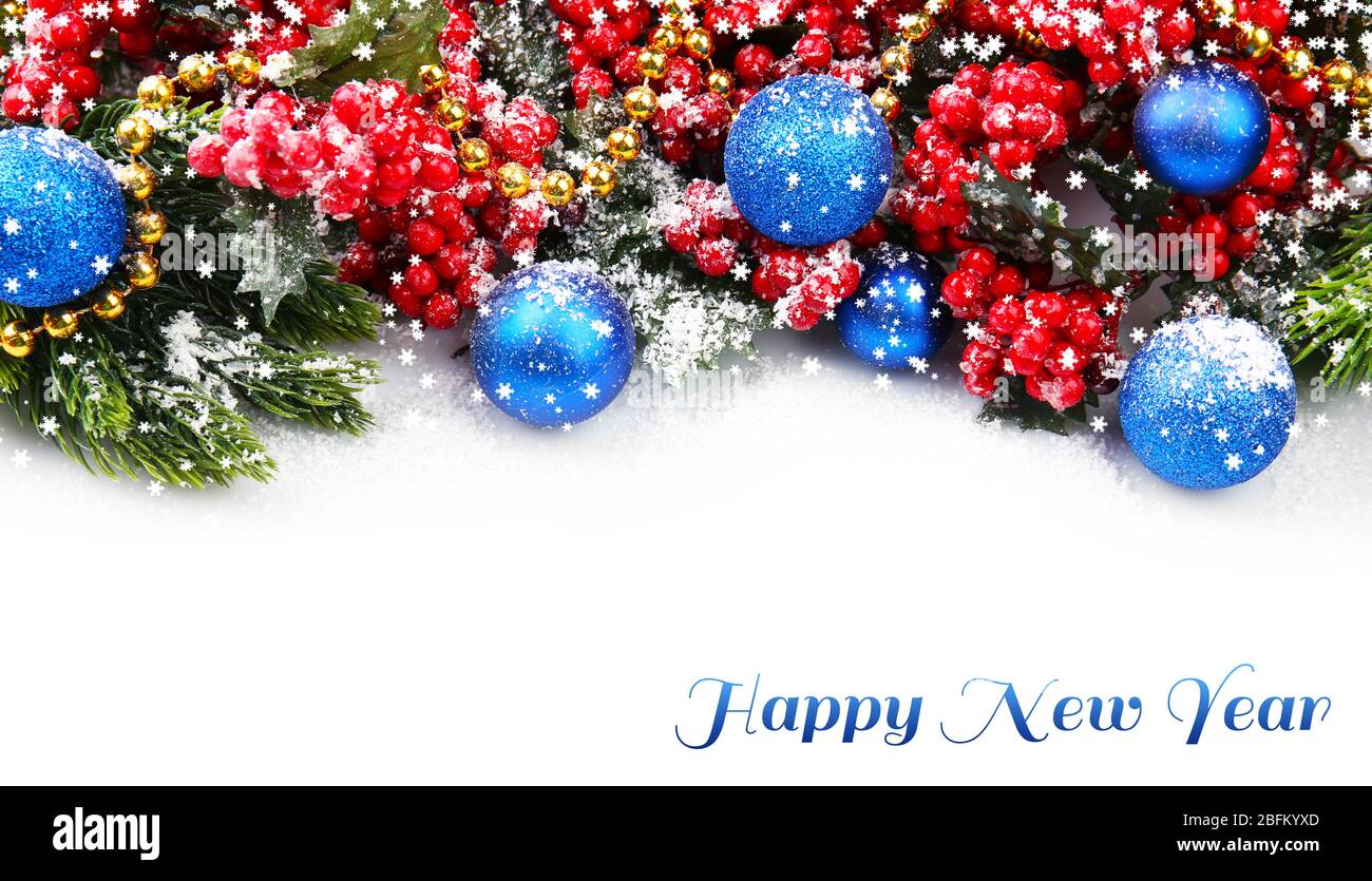 Christmas tree branch with red berries and decorations on white ...