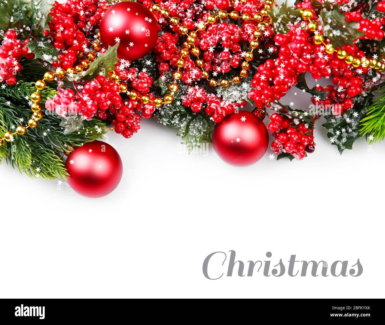 Christmas tree branch with red berries and decorations on white ...