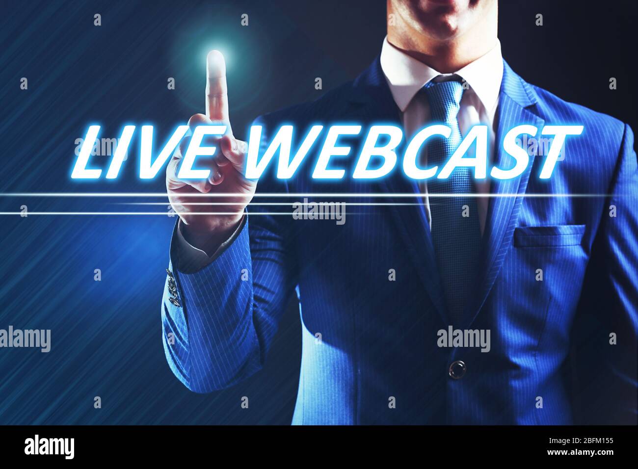 Businessman pressing live webcast button on virtual screen. Internet and networking concept. Stock Photo