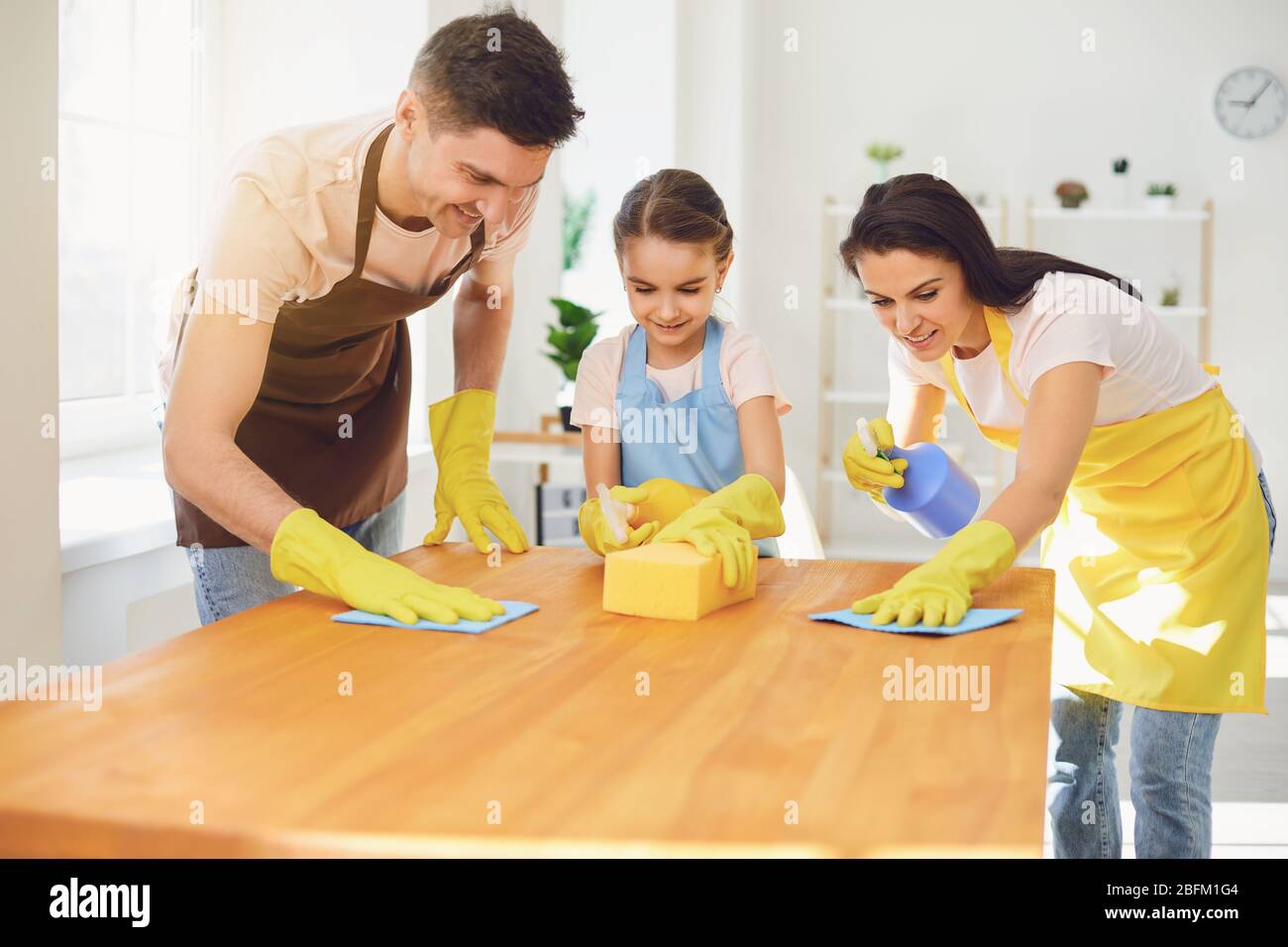 Happy family cleans the room in the house. Stock Photo