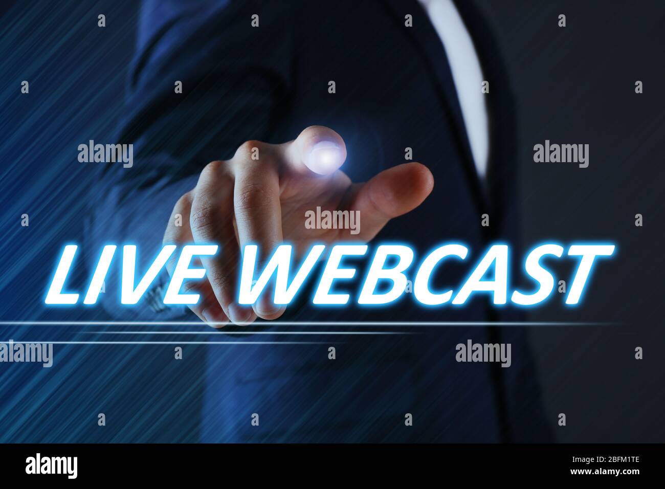 Businessman pressing live webcast button on virtual screen. Internet and networking concept. Stock Photo