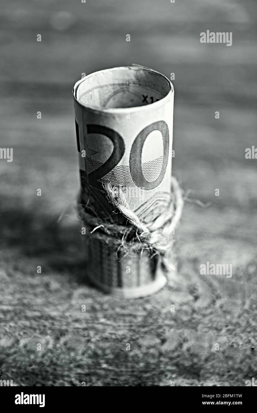 Roll of Euro banknotes on wooden background Stock Photo - Alamy