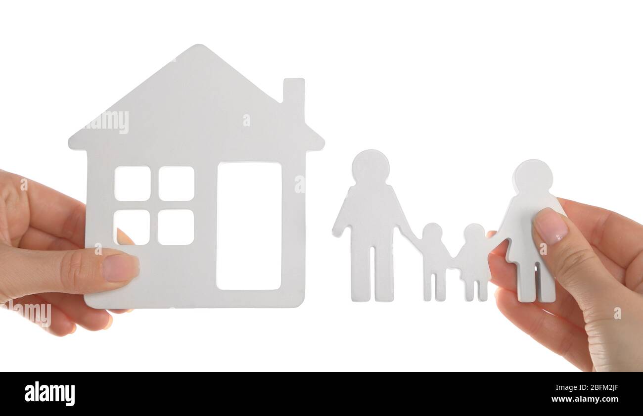 Female hands holding models of house and family isolated on white Stock ...