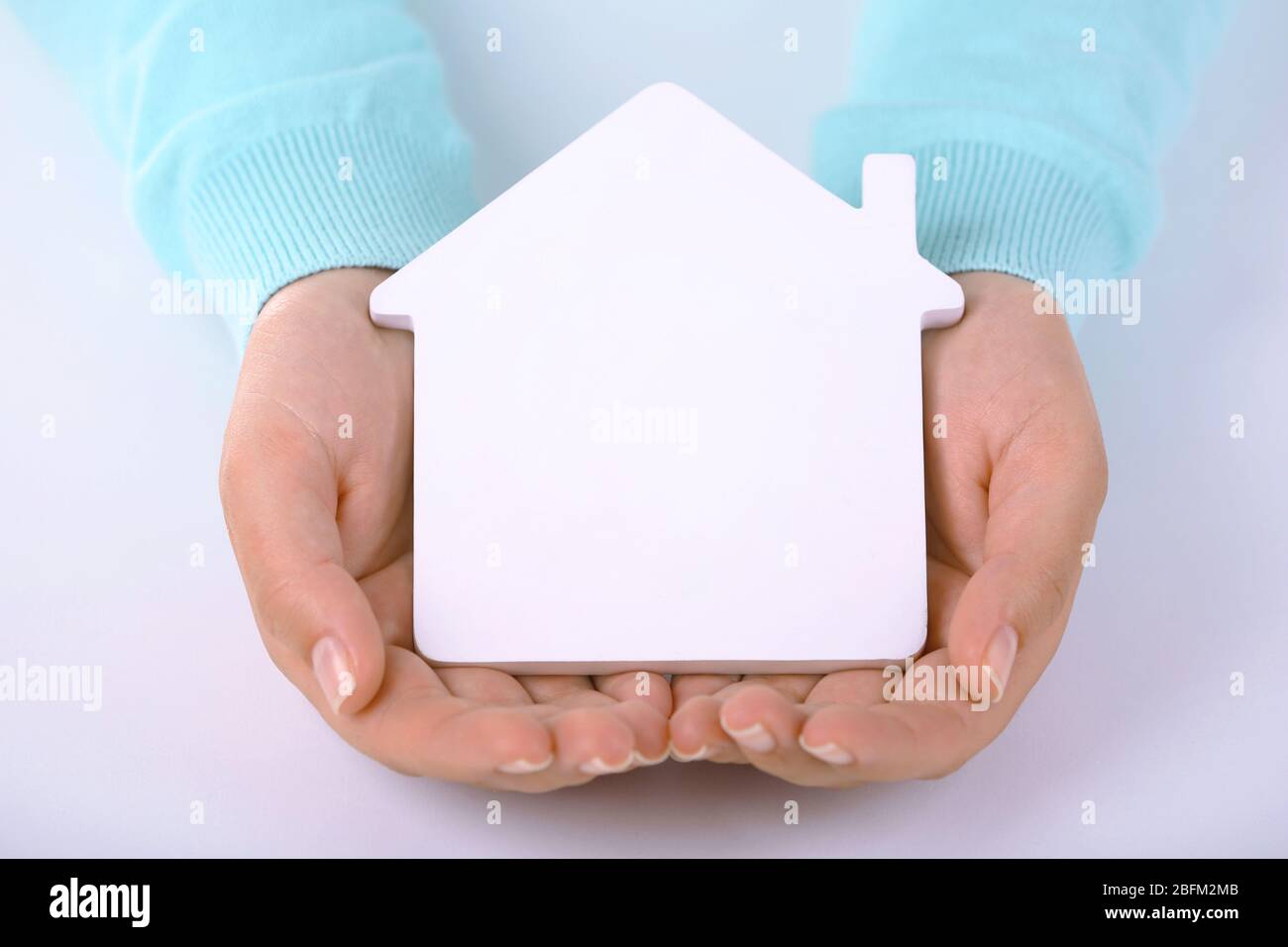 Female hands holding model of house, closeup Stock Photo - Alamy