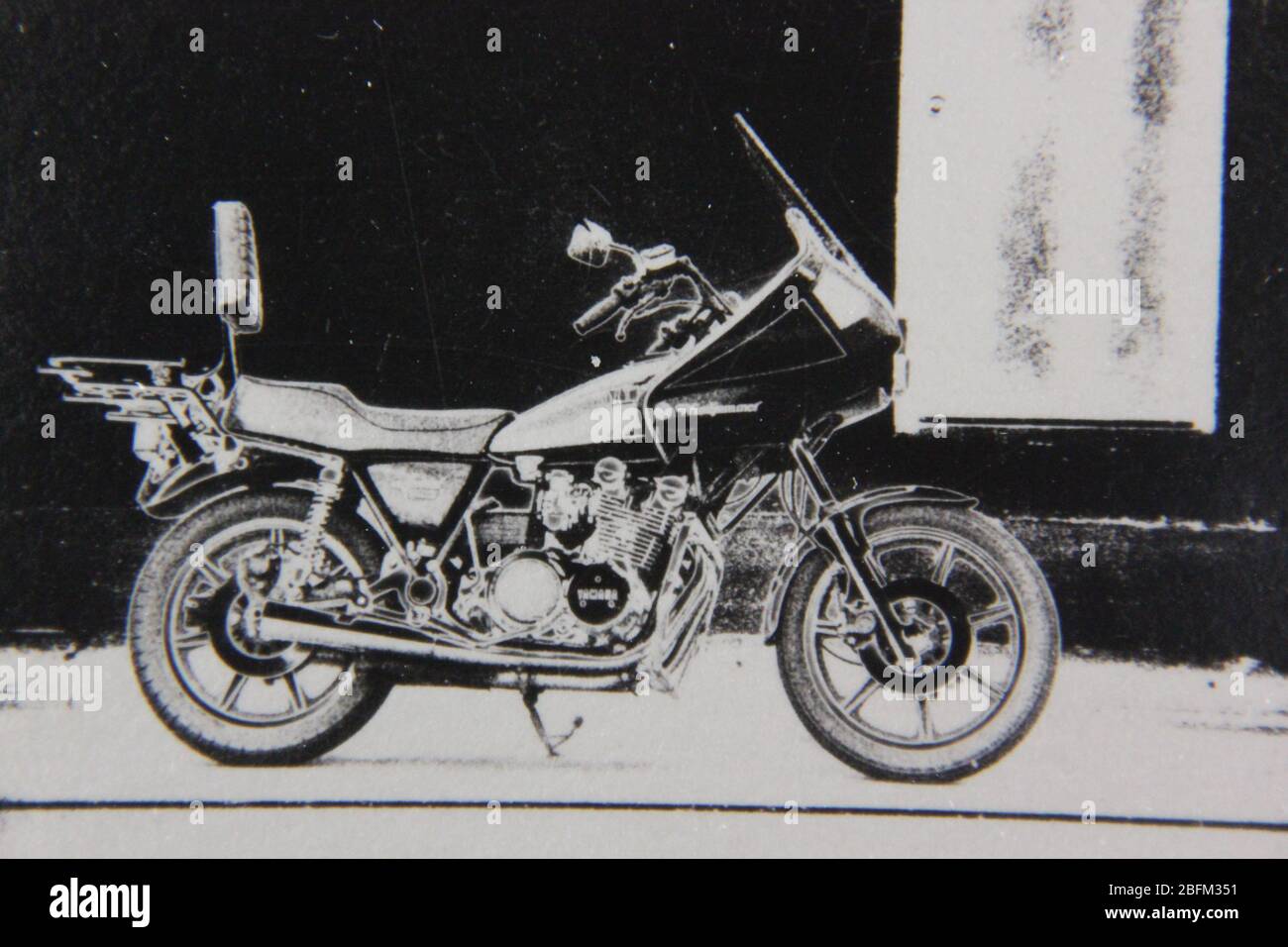 Fine 70s vintage black and white extreme photography of a motorcycle parked on the street Stock Photo