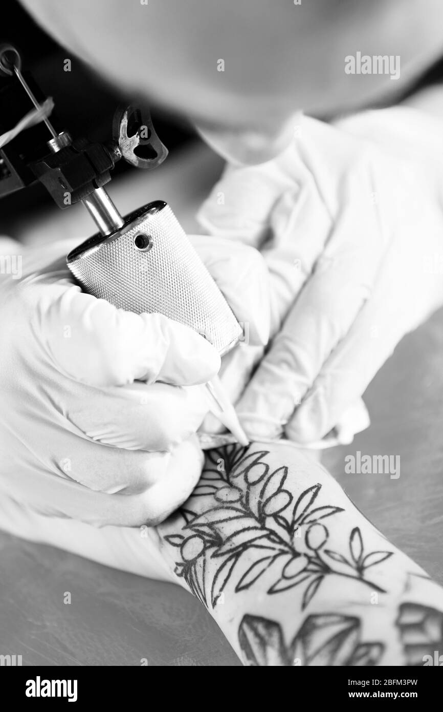 Professional tattoo artist doing tattoo, close up Stock Photo Alamy