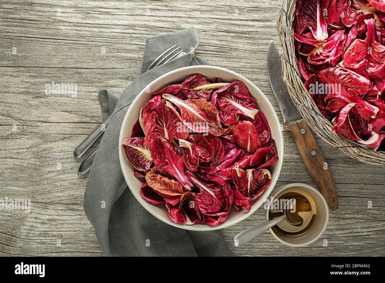 Healthy red lettuce salad meal on wooden table background. Freshly picked radicchio Stock Photo