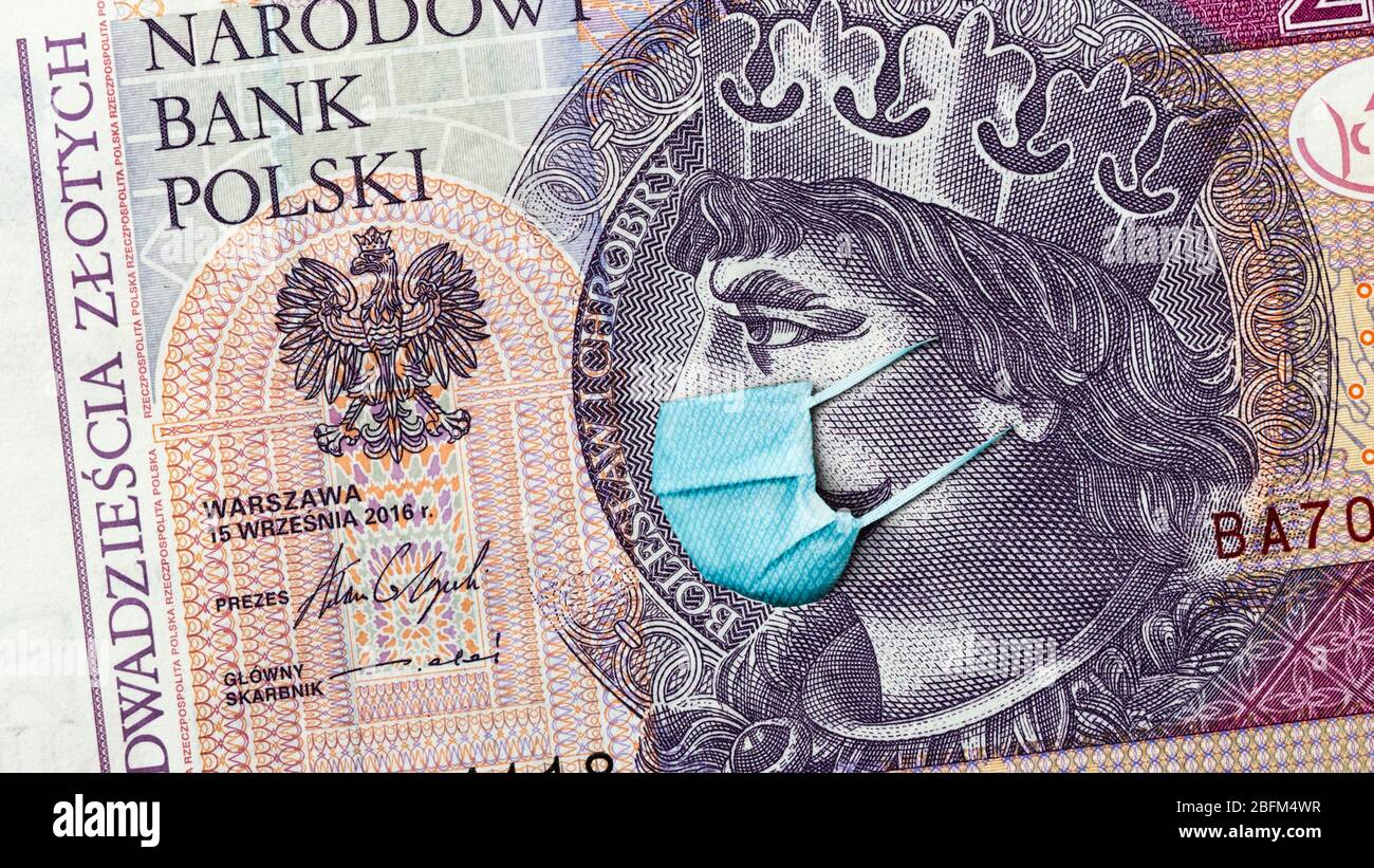 Coronavirus in Poland. Quarantine and global recession. 20 Polish zloty banknote with face mask against infection. Global economy hit by covid19. Stock Photo