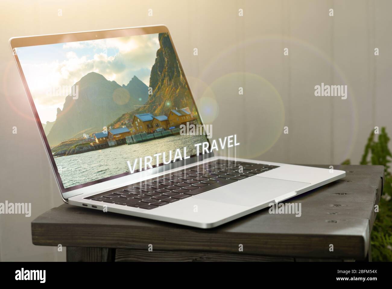Computer with a view of the bay in the mountains on the screen. Virtual travel Stock Photo