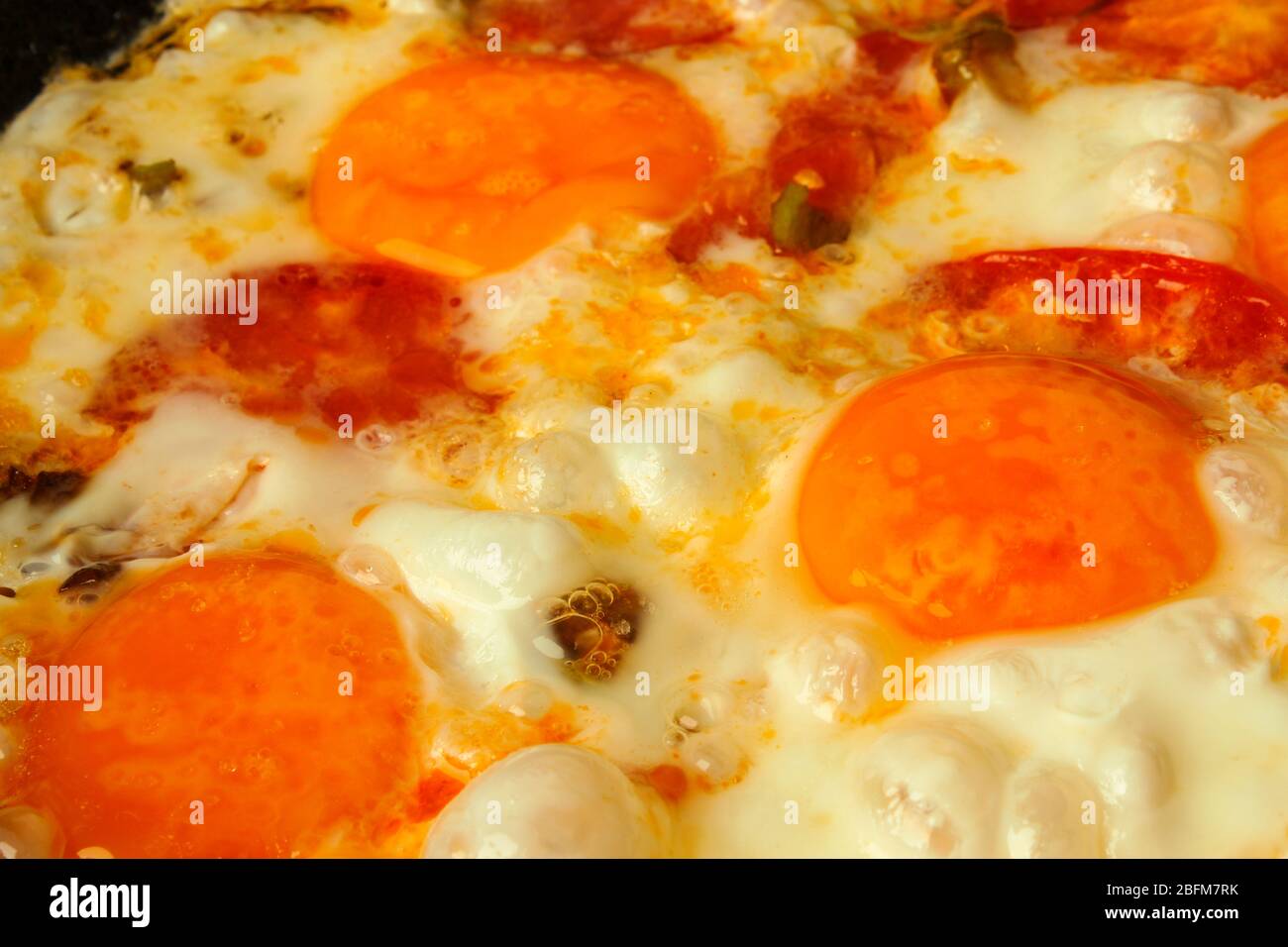 Fried eggs close-up in a pan as a background Stock Photo