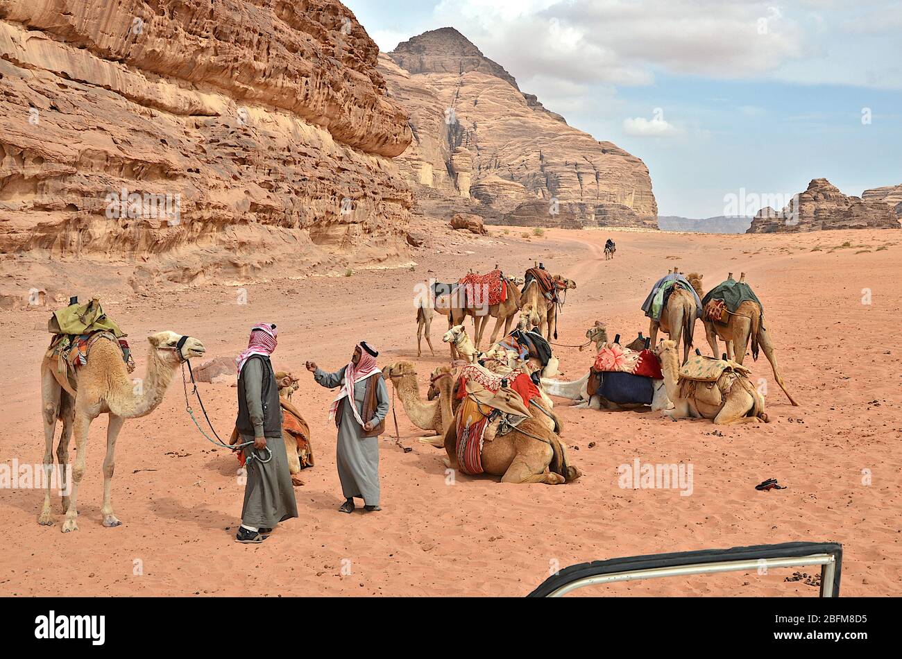 Bedouins talking near a camel camp in Wadi Rum desert, Southern Jordan Stock Photo