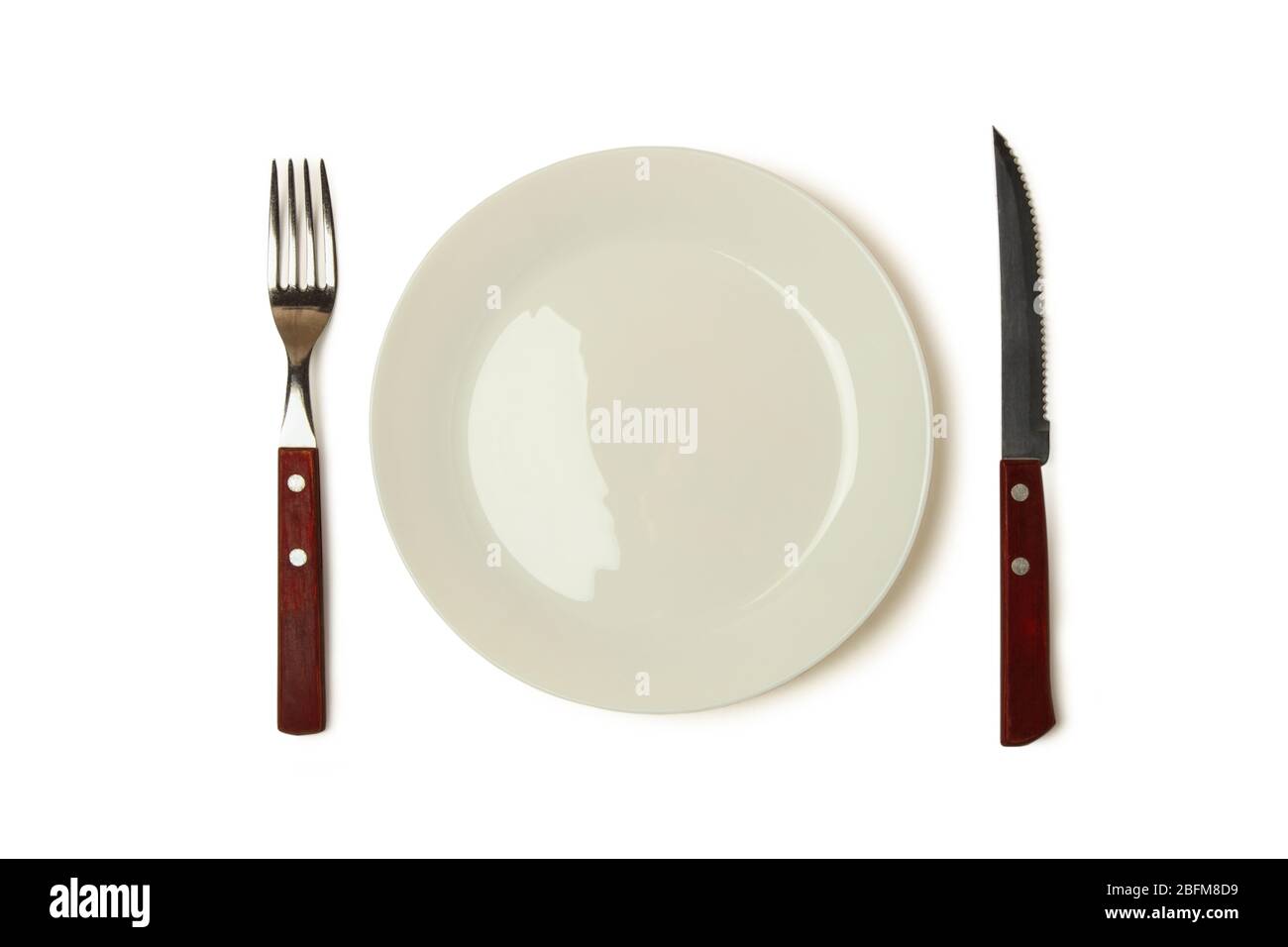 Knife, fork and plate isolated on white background Stock Photo