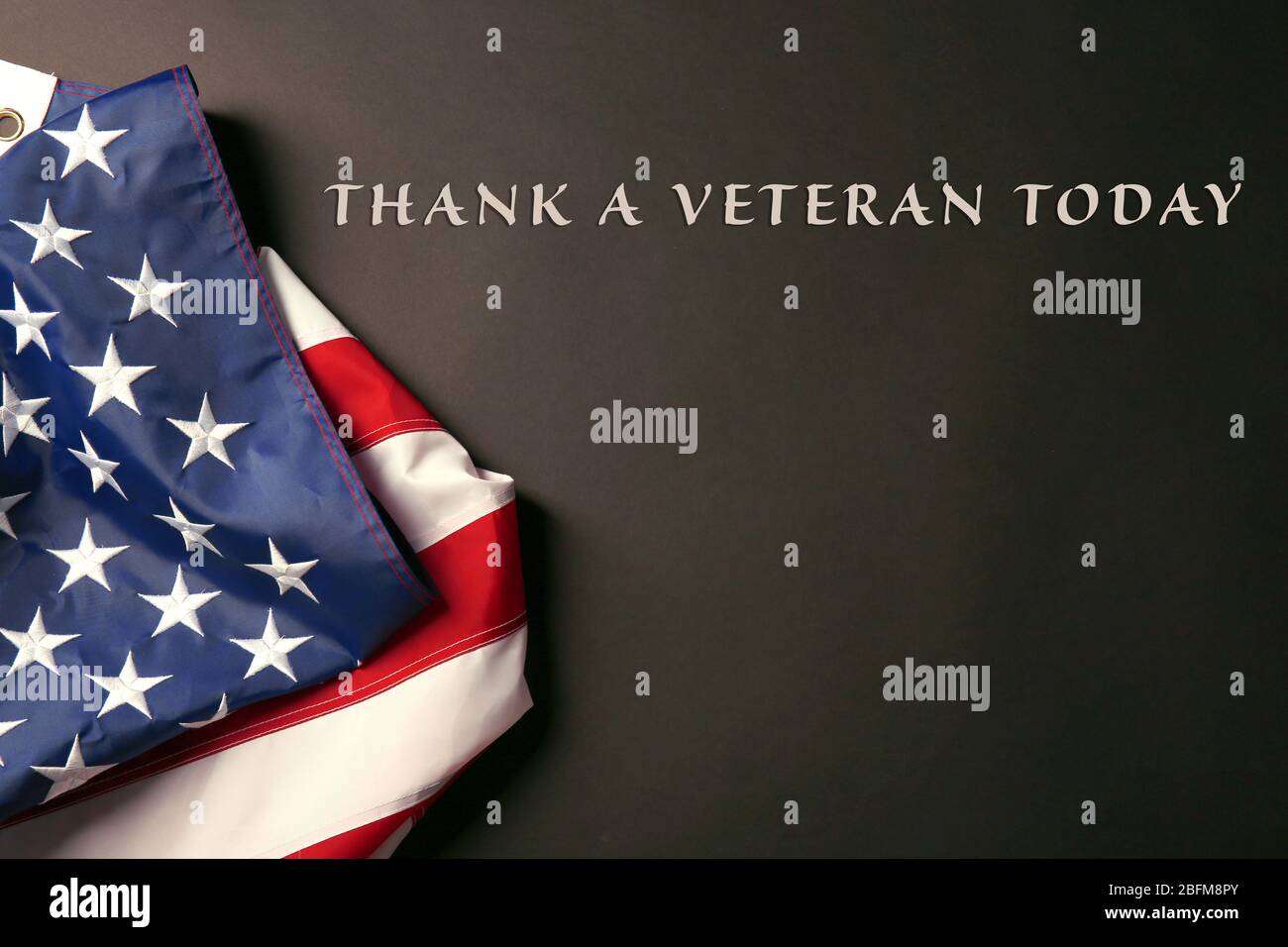 Text Thank A Veteran Today on black background near American flag Stock ...