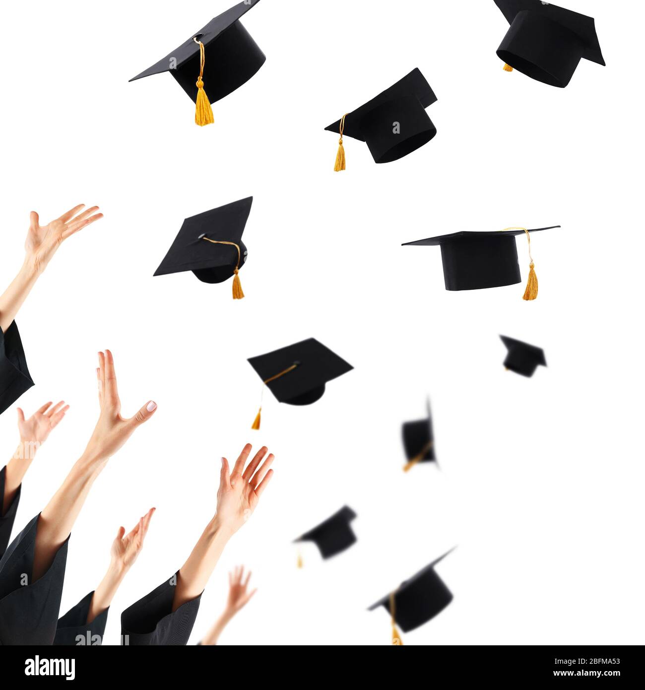 Graduates hands throwing graduation hats , isolated on white Stock
